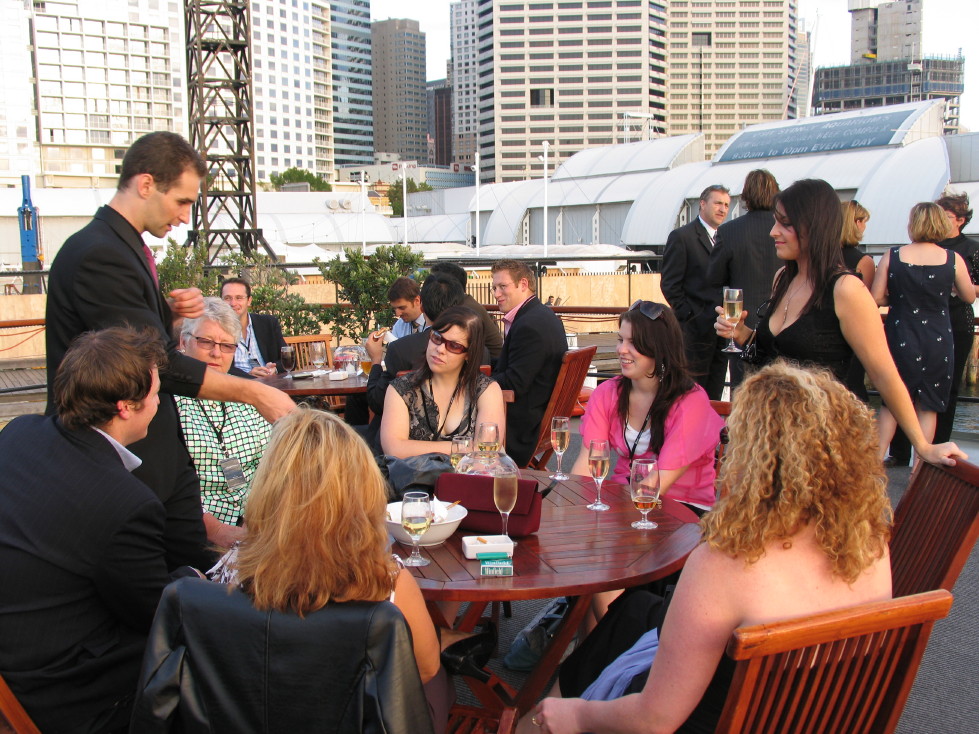 Craig performing close-up magic for guests at an outdoor reception